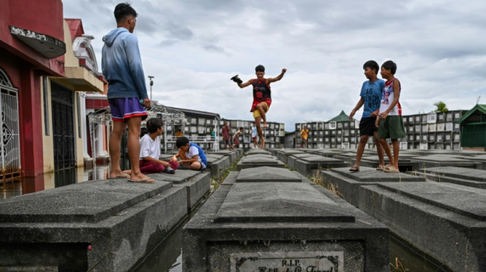 Filipinos brave crowds, flooding for All Saints' Day cemetery visits