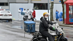 'Iron army' of grocery runners feeds Shanghai as Covid hits